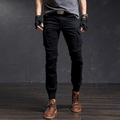 Close-up of men's tactical cargo pants, tapered fit, cuffed ankle. Utility pockets detail, adventure ready.