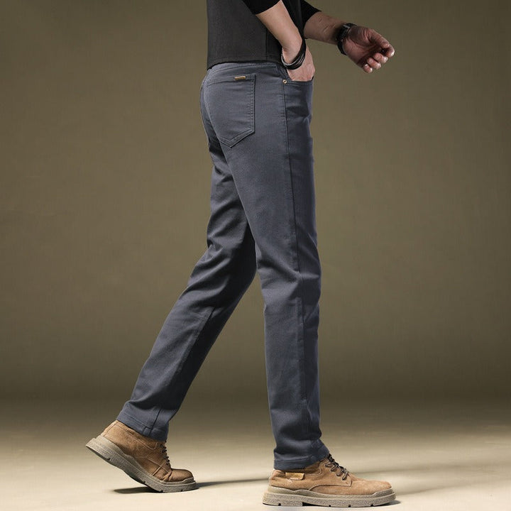Detail shot of the tailored waist and pocket of men's premium cotton trousers, refined style.