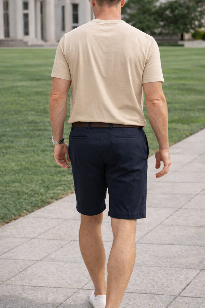 Stylish men's flat-front tailored shorts with comfortable stretch. Essential for smart casual summer outfits.