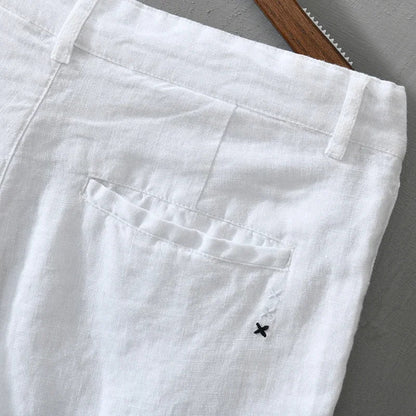 Stack of men's lightweight linen shorts in various colors, essential for a versatile warm weather wardrobe.