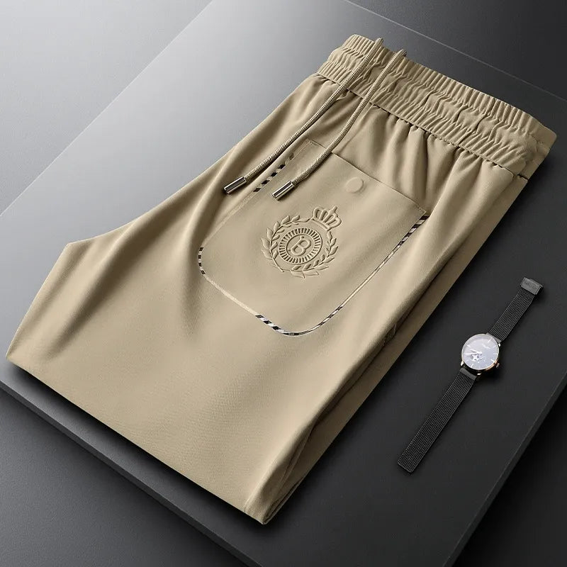 Detail of the waistband and front closure on men's slim fit tailored cotton pants.