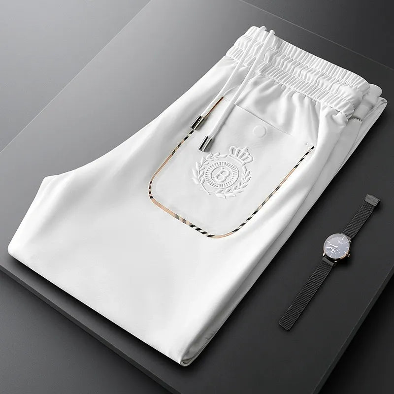 Model wearing elegant men's slim fit tailored cotton dress pants for a sharp business look.
