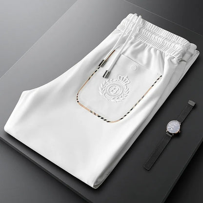 Model wearing elegant men's slim fit tailored cotton dress pants for a sharp business look.