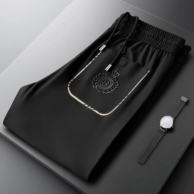 Neatly folded pair of men's tailored slim fit cotton trousers, ready for formal wear.