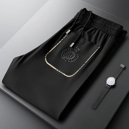 Neatly folded pair of men's tailored slim fit cotton trousers, ready for formal wear.
