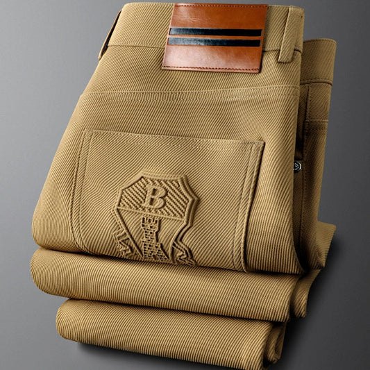 Men's tailored woven trousers with elegant leather accent for a sophisticated look.