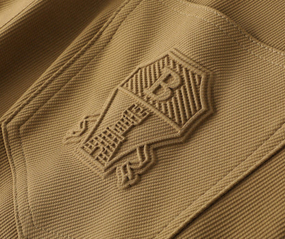 Khaki men's tailored woven trousers with a stylish leather patch, ideal for formal or casual wear.