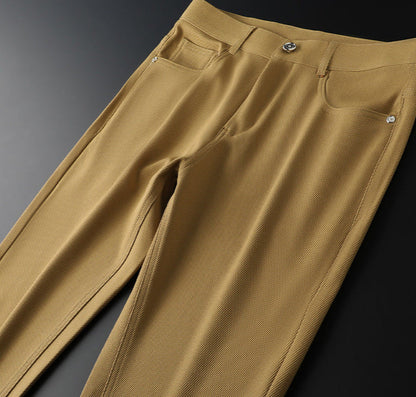 Stylish men's tailored woven pants featuring a unique leather accent, versatile for any occasion.