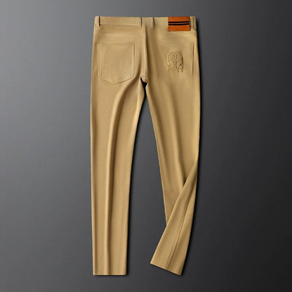 Versatile men's tailored woven trousers with leather patch, suitable for formal and smart casual outfits.