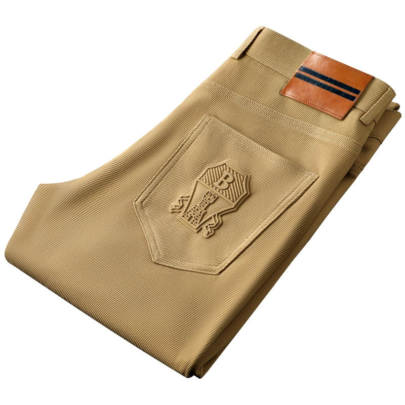 Close-up of the leather accent on men's tailored woven trousers, highlighting quality and style.