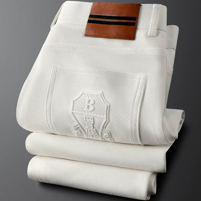 Beige men's tailored woven trousers with a sophisticated leather patch, a must-have in men's fashion.