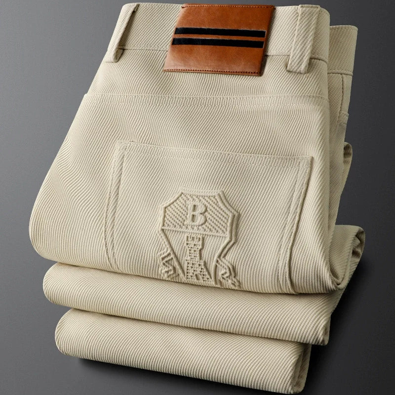 Men's casual woven trousers, tailored fit, with a distinctive leather patch, comfortable & stylish.