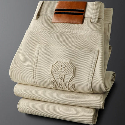 Men's casual woven trousers, tailored fit, with a distinctive leather patch, comfortable & stylish.