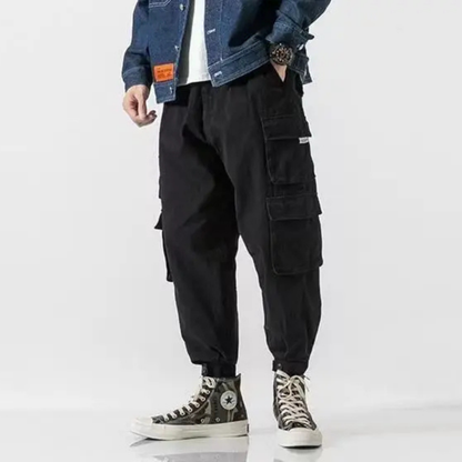Explore in comfort: men's tapered cargo pants with elastic cuffs and roomy pockets.