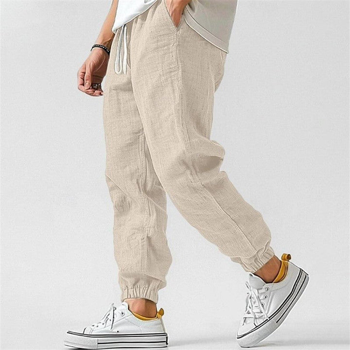 Modern men's tapered joggers with cuffed ankles, featuring a drawstring for ultimate casual comfort.