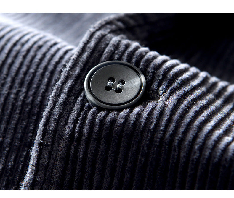 Detail of a men's casual textured blazer jacket lapel, showcasing quality and fall style.