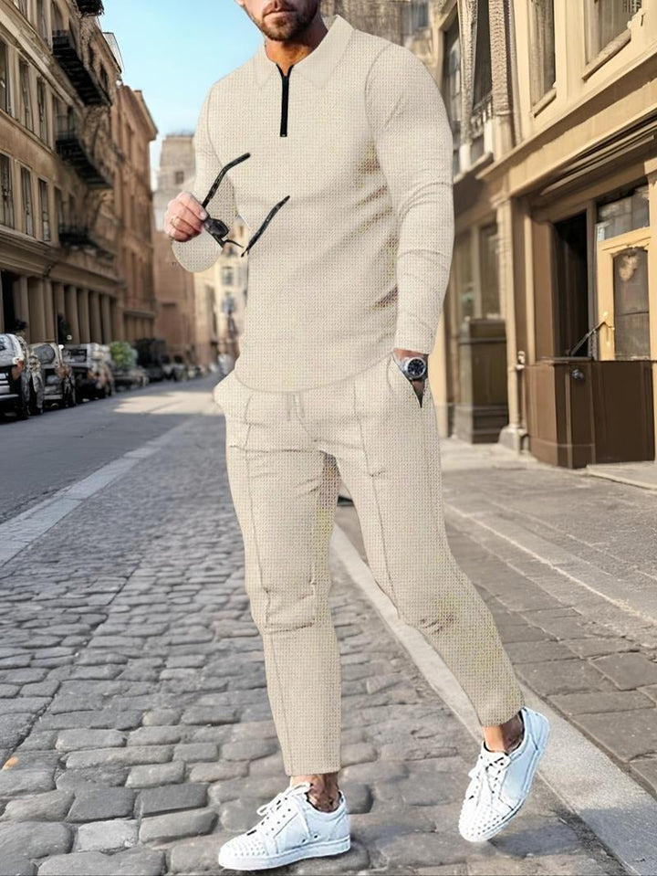 Men's zip neck lounge set featuring textured knit cotton blend fabric and comfortable drawstring pants for leisure.