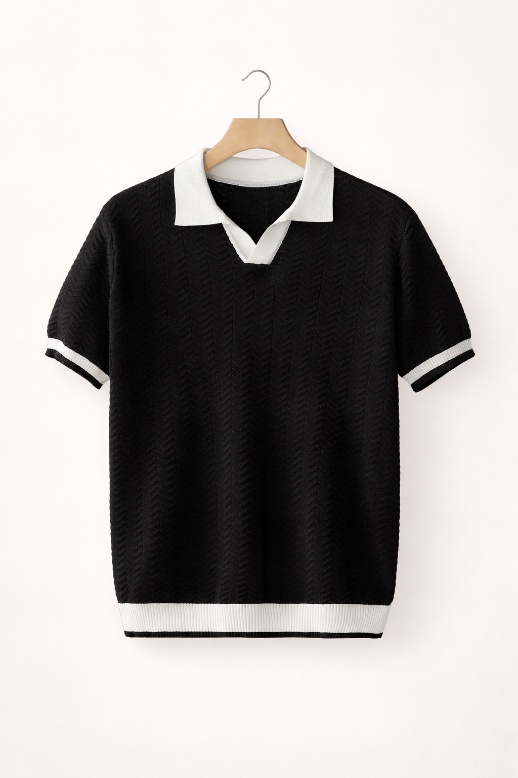 Close-up of a men's modern fit textured polo shirt with short sleeves, showcasing fabric detail.