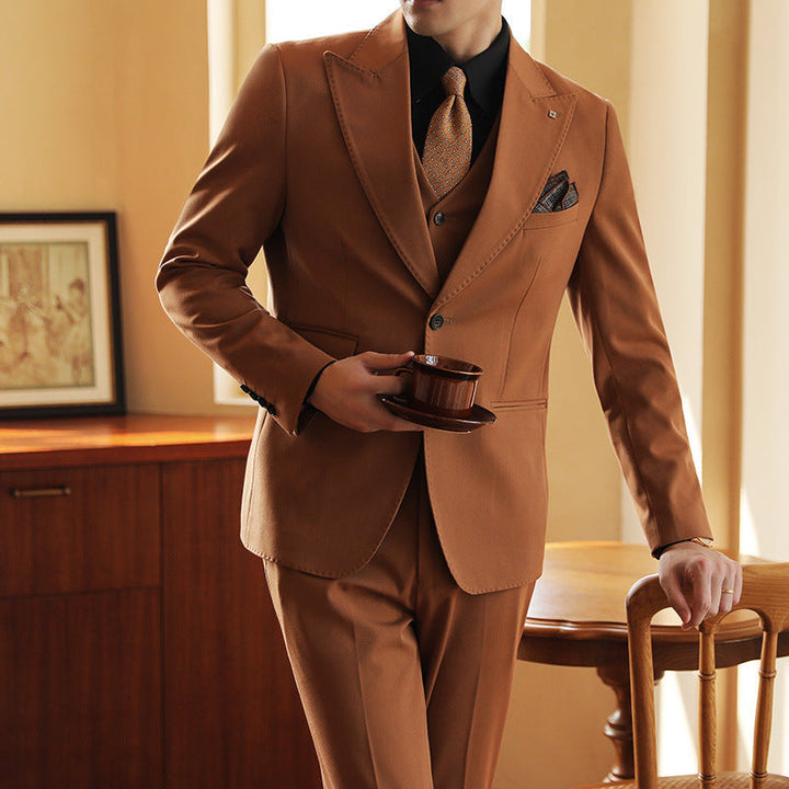 Dark green three-piece men's formal suit. Modern wedding & event attire with a slim fit.