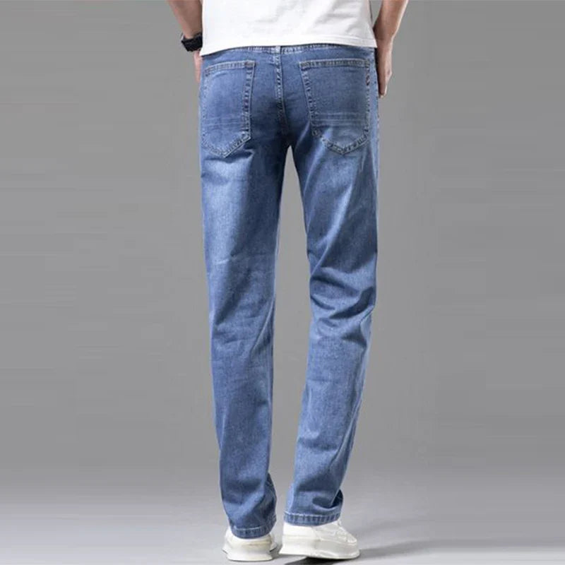 Close-up of Men's Torino straight fit blue denim jeans fabric, showcasing stretch cotton texture & quality.