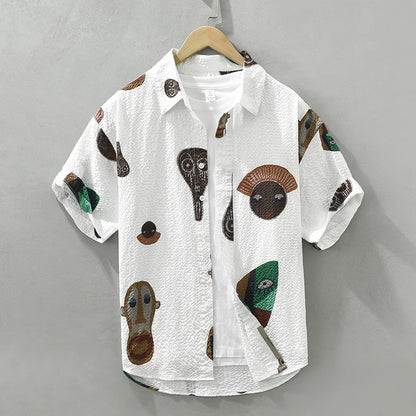 Men's tribal art print button-up shirt. Features abstract Cubist design, perfect for unique casual wear.
