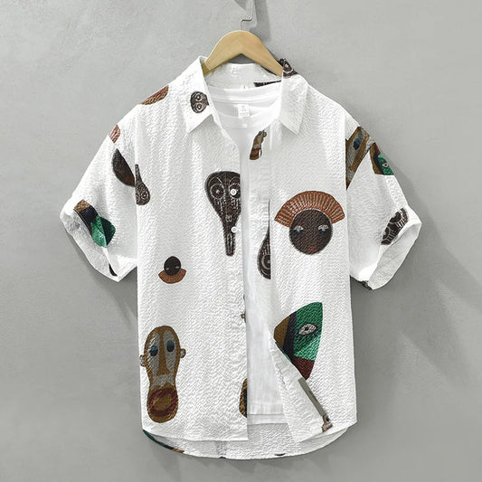 Men's tribal art print button-up shirt. Features abstract Cubist design, perfect for unique casual wear.