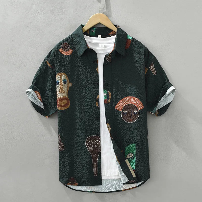 Graphic men's shirt with bold tribal art print. Stylish button-up for a unique fashion statement.