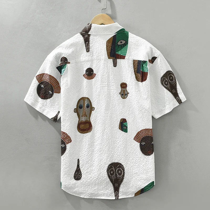 Casual men's button-up shirt featuring a vibrant abstract tribal art print. A standout graphic shirt.