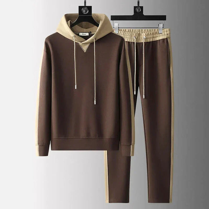 Man wearing a comfortable two-tone lounge set with joggers & crewneck. Ideal for relaxation & casual style.