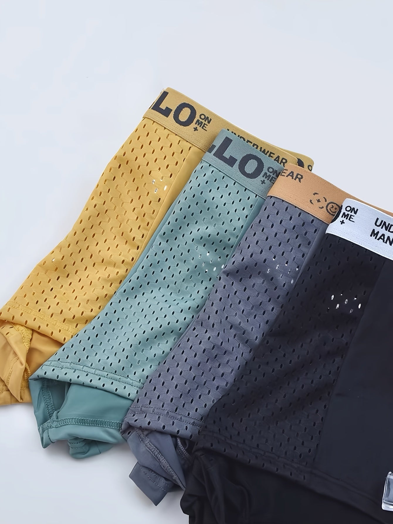 Comfortable no-roll waistband on men's mesh boxer briefs 3/4-pack, ideal for active & everyday wear.