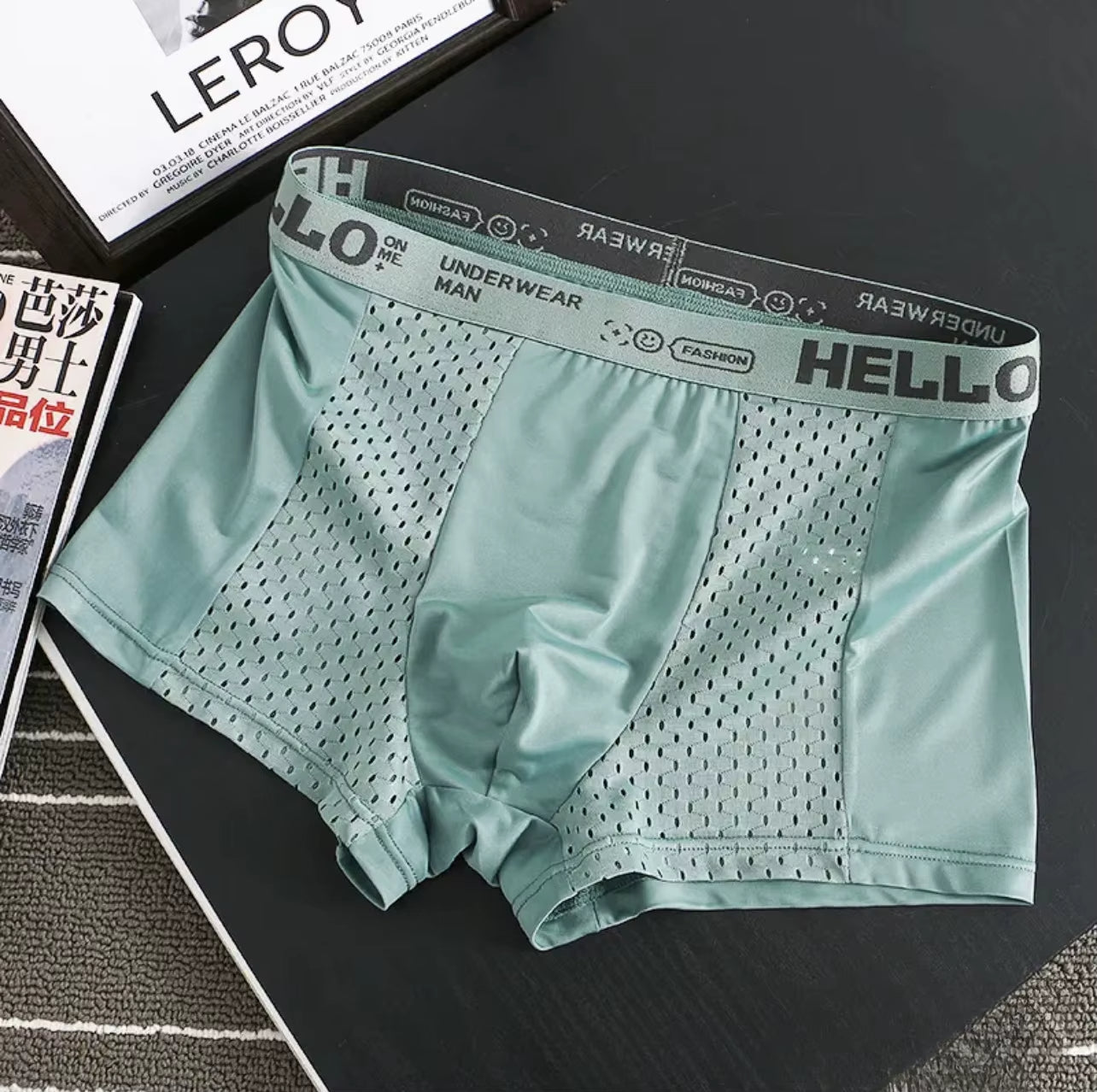 Side view of model in sweat-wicking men's mesh boxer briefs, ensuring comfort & quick-dry performance.