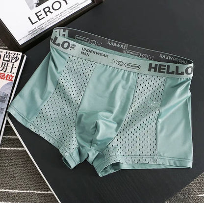 Side view of model in sweat-wicking men's mesh boxer briefs, ensuring comfort & quick-dry performance.