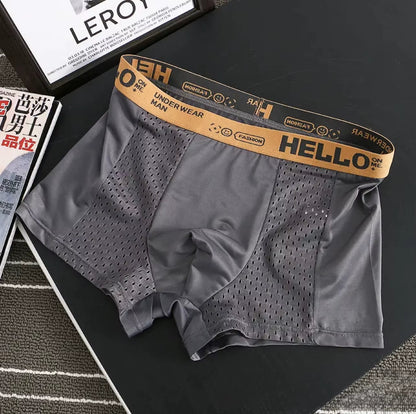 Rear view of model showcasing form-fitting stretch mesh boxer briefs for active comfort.
