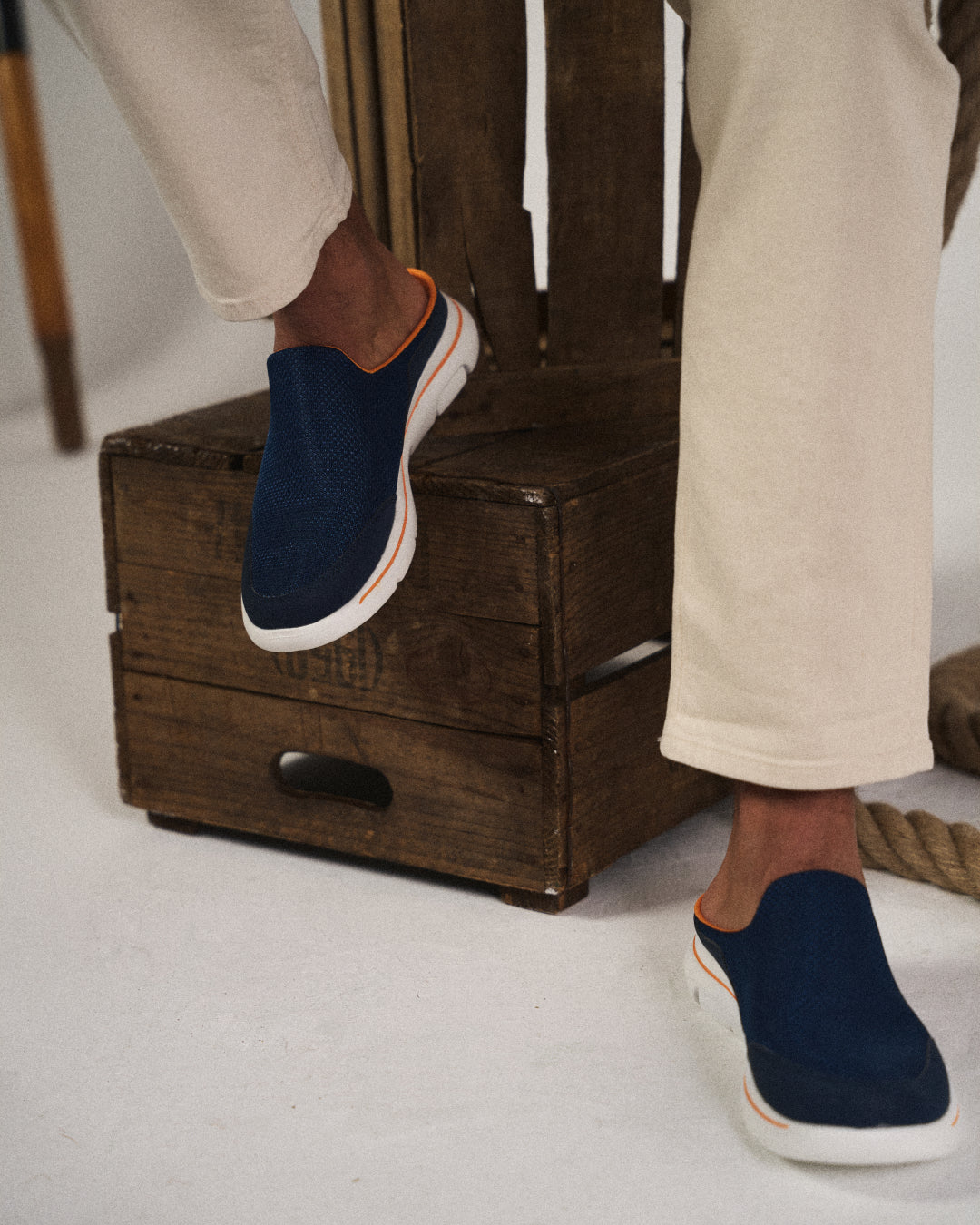 Men's feet comfortably slipping into ultra-comfort backless sneaker slides for easy wear.
