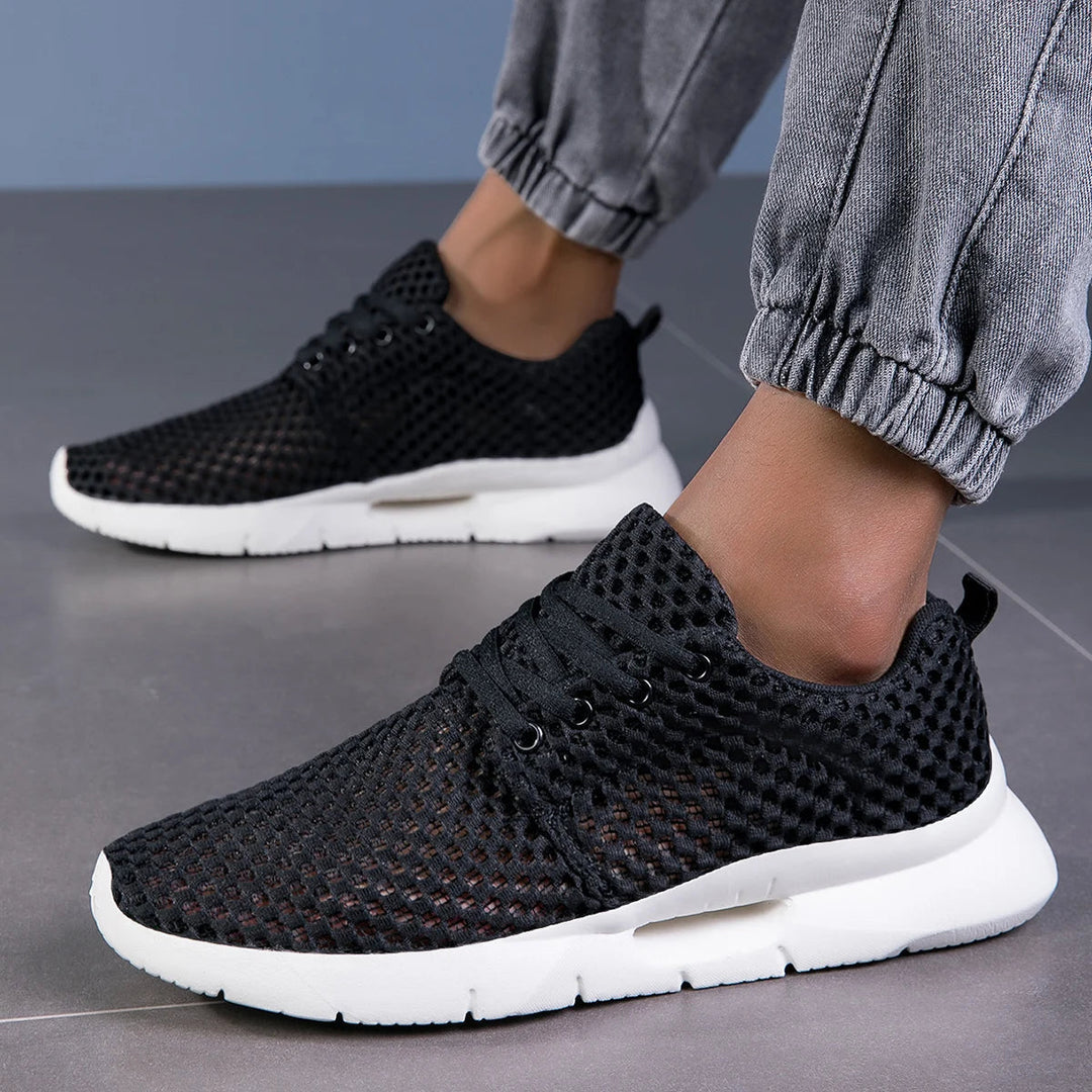 Close-up of breathable mesh on men's lightweight athletic sneakers, ensuring all-day comfort.