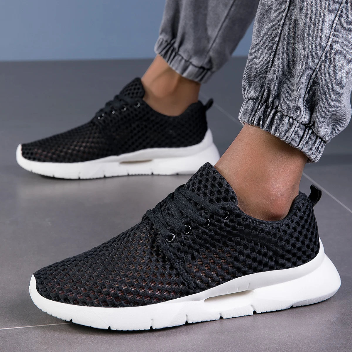 Close-up of breathable mesh on men's lightweight athletic sneakers, ensuring all-day comfort.