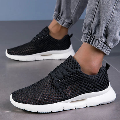 Close-up of breathable mesh on men's lightweight athletic sneakers, ensuring all-day comfort.