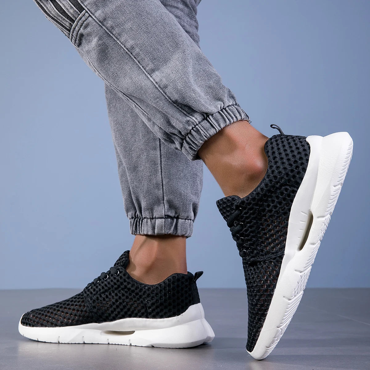 Men's ultra-light breathable athletic shoes in action, providing comfort for running & walking.