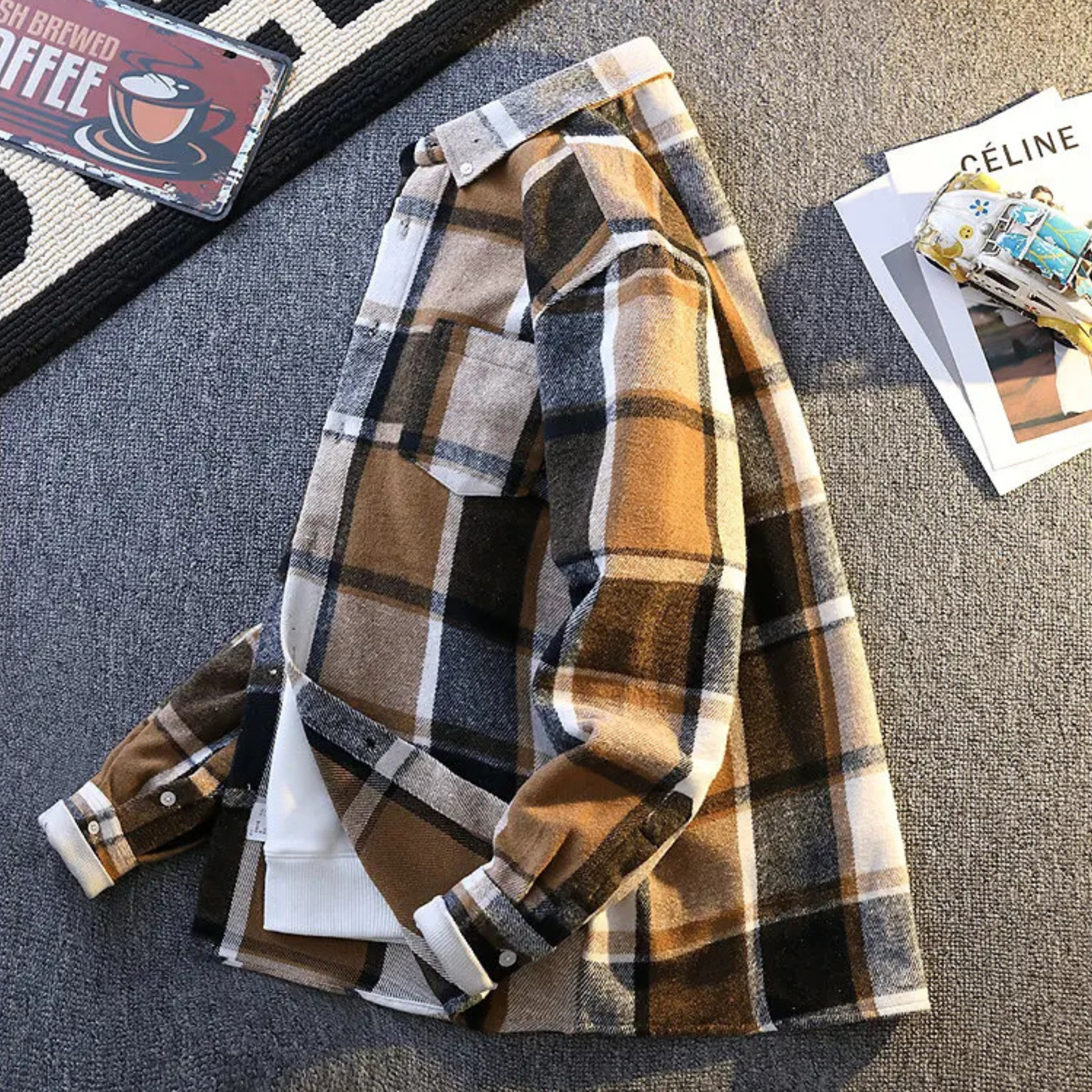Rugged men's plaid button-up shirt, ideal long sleeve layering top for casual wear.