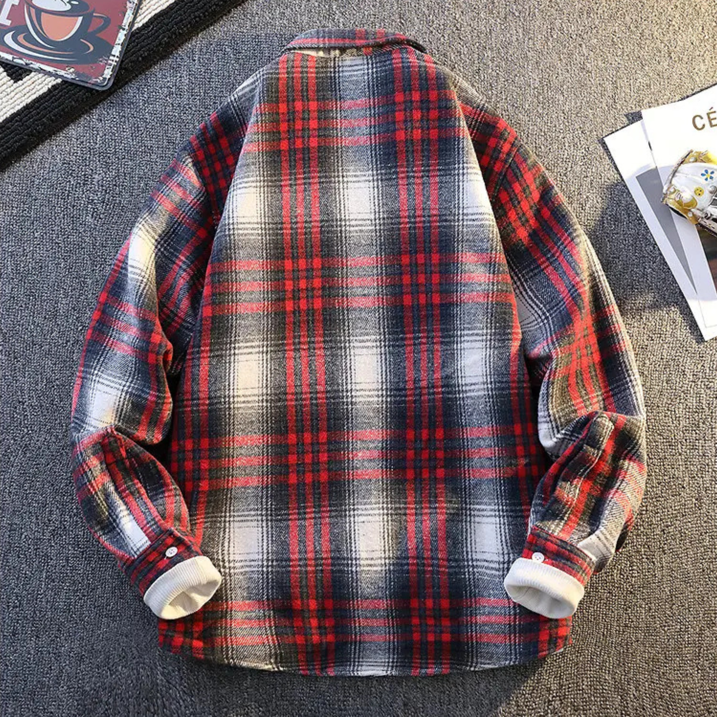 Close-up of soft plaid fabric on a men's warm long sleeve button-up casual shirt.