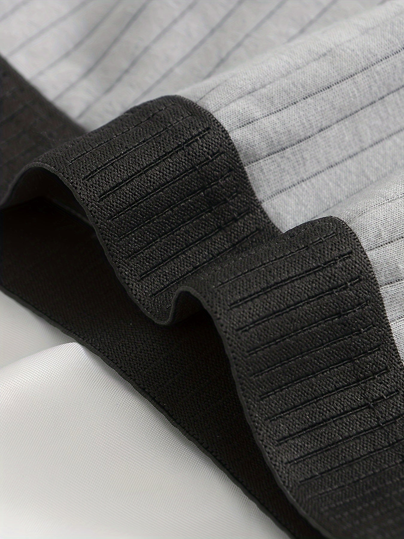 Detail shot of ultra-soft ribbed modal fabric on men's boxer briefs, highlighting luxurious feel.