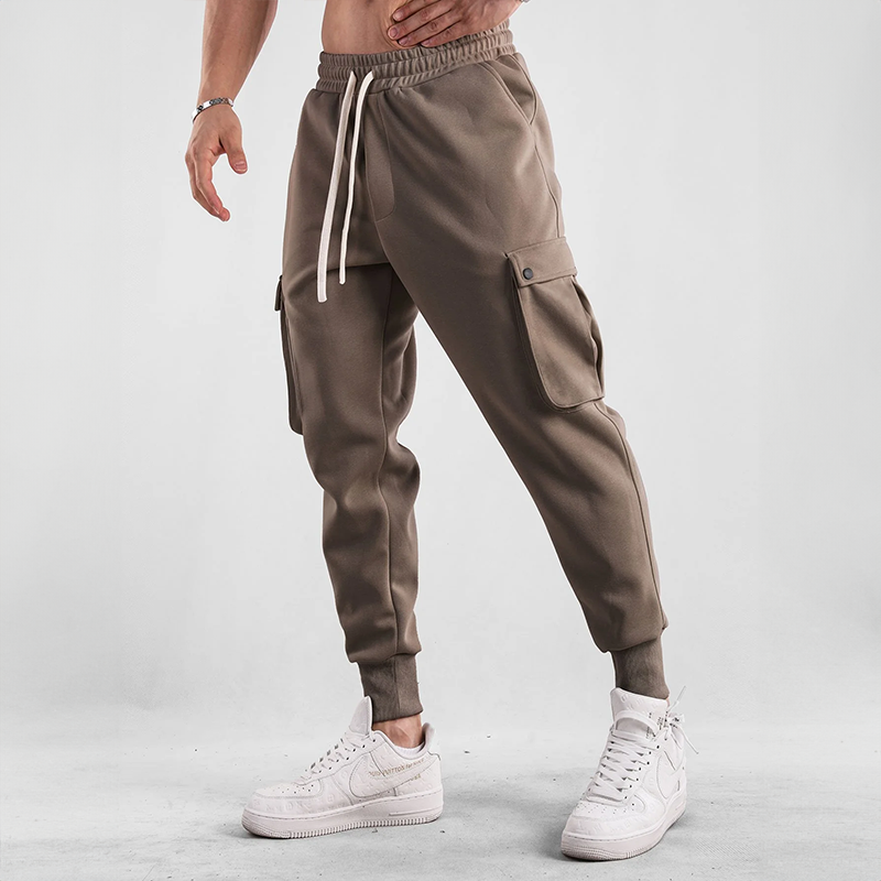 Man walking outdoors in Men's Urban Flex Cargo Joggers, versatile casual pants for daily adventures.