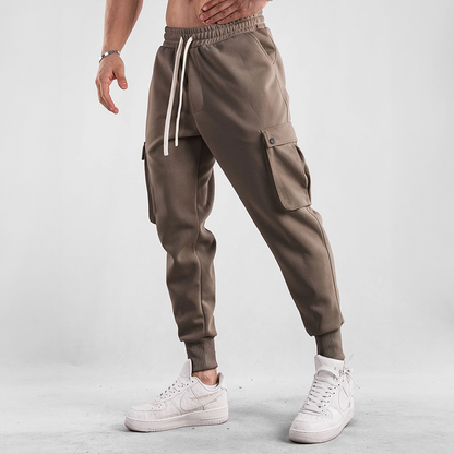 Man walking outdoors in Men's Urban Flex Cargo Joggers, versatile casual pants for daily adventures.