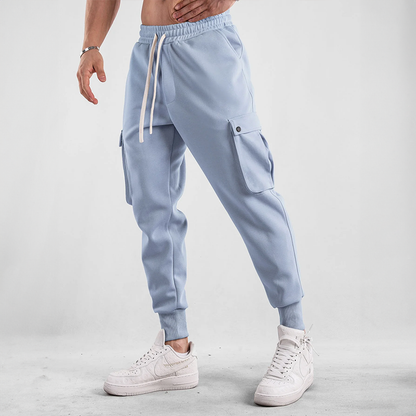 Man actively moving in Men's Urban Flex Cargo Joggers, perfect for athletic activities & casual comfort.