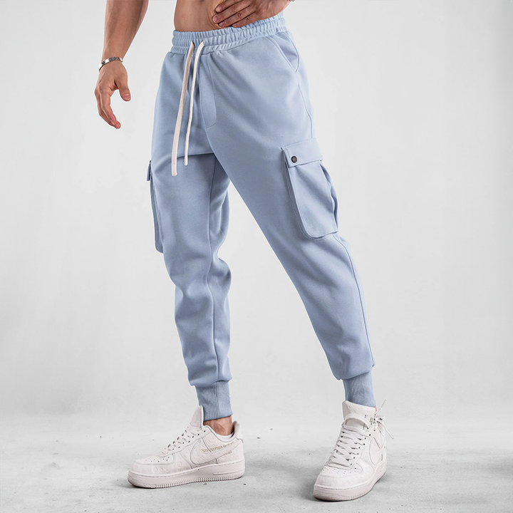 Man actively moving in Men's Urban Flex Cargo Joggers, perfect for athletic activities & casual comfort.