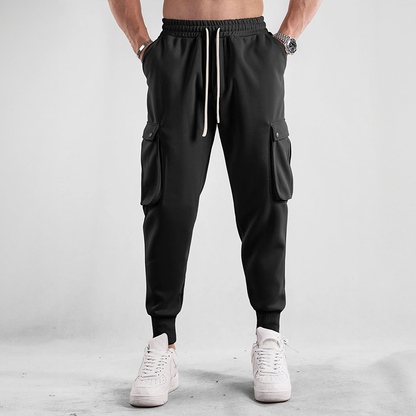 Man relaxing in comfortable Urban Flex Cargo Joggers, ideal loungewear & everyday bottom wear.