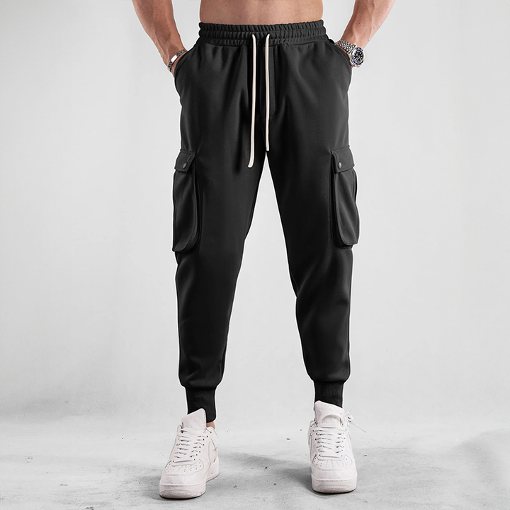 Man relaxing in comfortable Urban Flex Cargo Joggers, ideal loungewear & everyday bottom wear.