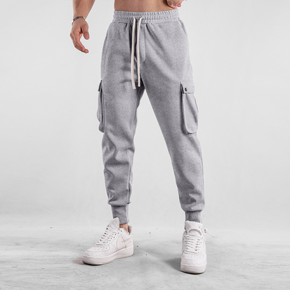 Stack of Men's Urban Flex Cargo Joggers in multiple colors, comfortable, versatile loungewear.