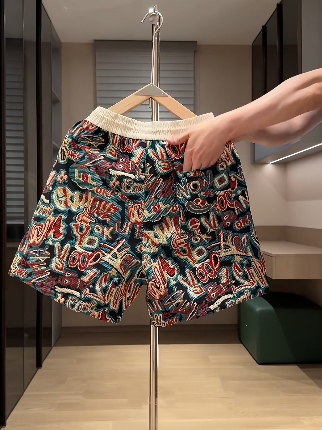 Comfortable men's drawstring shorts with a vibrant urban graffiti print, perfect for loungewear or street style.