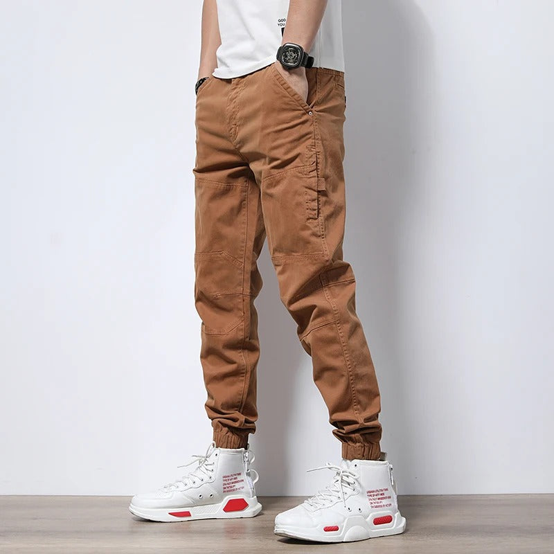 Durable men's reinforced cargo joggers, designed for urban exploration & long-lasting comfort; stretch fabric.